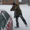 Fang clears snow from the car